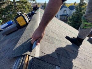 Pointing at the top edge a roof shingle